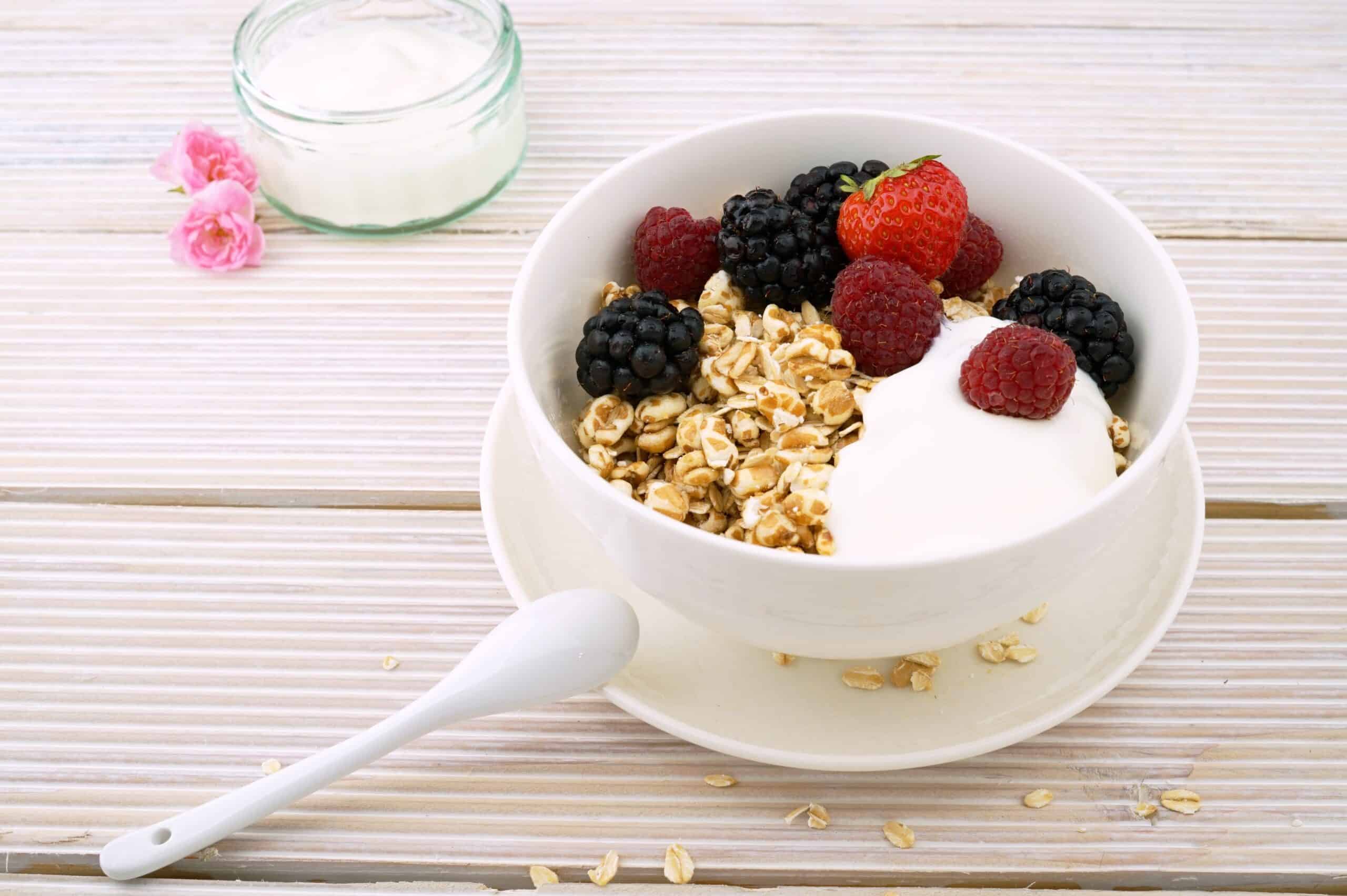 Healthy vegan breakfast bowl with oats, berries, and coconut yogurt.